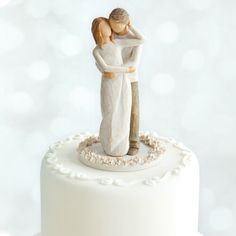 a wedding cake topper with a bride and groom figurine on the top