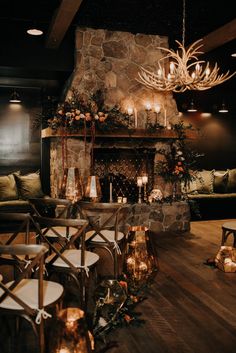 a living room filled with furniture and a fire place covered in lots of greenery