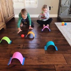 two children playing with toys on the floor