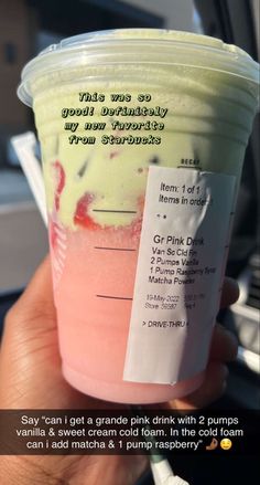 someone is holding up a pink drink in their hand, with the price label on it