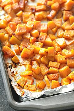 baked sweet potatoes on tin foil in a baking pan