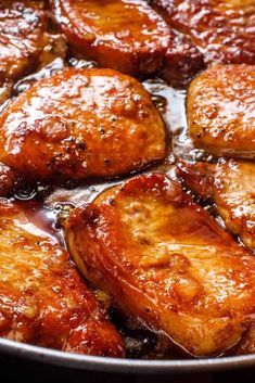 some chicken is cooking in a skillet on the stove top and it looks like they have been cooked