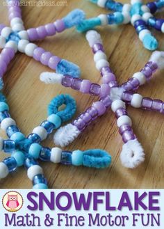 beads are arranged in the shape of a snowflake on a wooden table top