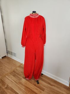 This vintage jumpsuit romper is a fun addition to any wardrobe. Gigette The red romper has two pockets and zippers up the front. The fabric feels reminiscent of velour, but not quite. Total length: 55 inches Sleeve length: 22 inches Chest: 37 inches Waist: 37 inches Hips: 40 inches Inseam: 27.5 inches This piece is in good vintage condition with some wear and age. There is a few light spots (such as in the last photo). Feel free to send me any questions! Red Long Sleeve Jumpsuits And Rompers For Loungewear, Red Long Sleeve Jumpsuit For Loungewear, Retro Long Sleeve Jumpsuits And Rompers For Fall, Retro Long Sleeve Jumpsuit For Fall, Vintage Jumpsuits And Rompers For Fall, Retro Fitted Long Sleeve Jumpsuits And Rompers, Vintage Long Sleeve Jumpsuits And Rompers For Fall, Vintage Overalls And Rompers For Fall, Retro Fitted Long Sleeve Overalls