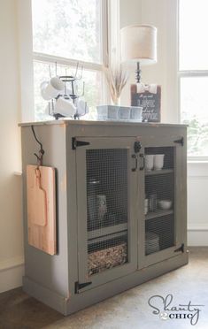 a gray cabinet sitting in front of a window