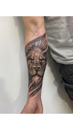 a man with a lion tattoo on his arm