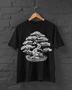 Bring the serene beauty of nature to your wardrobe with our Bonsai Print T-Shirt - a seamless blend of Harajuku style, Japanese Streetwear, and the elegance of a bonsai tree. This Anime Tee features a captivating design inspired by Japanese flora, making it a must-have for those who appreciate the graceful fusion of nature and culture. Whether you're strolling through Harajuku or expressing your love for Anime, this Japanese Tree Tshirt becomes a trendy and unique addition to your wardrobe. Elev Tree Tshirt, Japanese Shirt, Japanese Tree, Anime Tees, Y2k Clothing, Japanese Streetwear, Harajuku Fashion, Baggy Fits, Contemporary Fashion