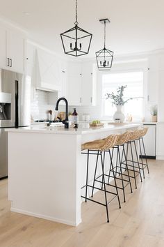 a kitchen with an island and bar stools