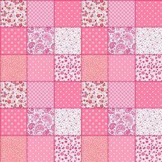 a pink and white patchwork quilt with hearts