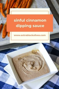 a bowl of dip next to sweet potato wedges on a blue and white checkered tablecloth