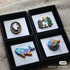 four different types of brooches in black boxes