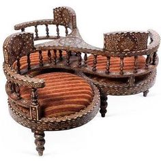 an ornately carved wooden chair and ottoman