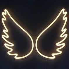 a neon sign with two wings on it