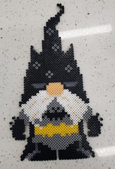 an image of a batman made out of perler beads on a white surface with grey speckles