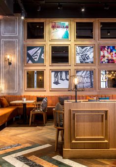 the interior of a restaurant with wooden booths