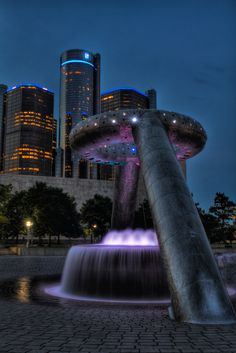 a water fountain in the middle of a city at night