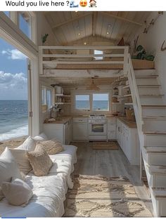 the interior of a beach house with stairs leading up to the kitchen