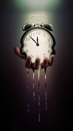 an alarm clock with dripping liquid coming out of it's hands in front of a black background