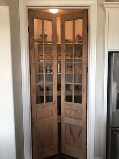 a wooden door with glass panels in a kitchen