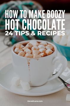 hot chocolate and marshmallows in a white cup with the words how to make boozy hot chocolate 24 tips & recipes