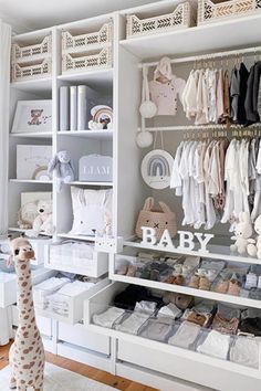 a baby closet with lots of toys and items on it's shelves, including a stuffed giraffe