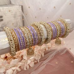 Celine Luxury Pearly Bangle Set - Lilac - SOKORA JEWELSCeline Luxury Pearly Bangle Set - LilacBANGLES Kaleera Ceremony, Light Purple Shades, Antique Gold Bangles, Brown Board, Wedding Jewelry Sets Bridal Jewellery, Indian Wedding Jewelry Sets, Pretty Jewelry Necklaces, Purple Shades, Fancy Jewellery Designs