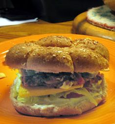 an orange plate with a sandwich on it