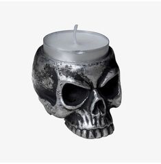 a skull shaped candle holder with a lit candle in it's mouth and the words, designs and images are property of alchemy england