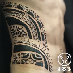 a black and white tattoo design on the side of a man's right arm