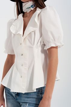 This romantic wrap blouse boasts of an oversized collar, trimmed with ruffles, volume sleeves, and a figure-flattering peplum silhouette in a stylish poplin fabric. The peplum silhouette drapes from your waist over your hips, making your waistline look slimmer. Ruffles adorn the placket and the sleeves are elastic on the ruffled cuffs. We style the top in our photos with our Heather Skinny Leg Distressed Jeans with Button Detail in Light Blue. Also available in green. Our model is 5’7” with meas Peplum Pattern, Frill Blouse, Puff Sleeve Shirt, Fashion Portfolio, Puff Sleeve Blouse, Ruffle Shorts, Wrap Blouse, Collar Blouse, Vintage Button