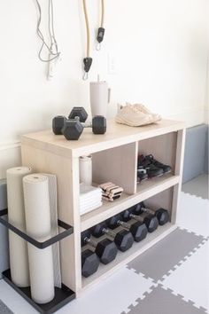 a shelf with various items on it in a room that has white walls and flooring