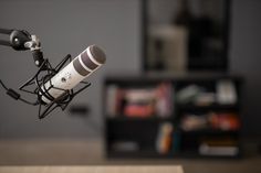 a microphone that is sitting on top of a table in front of a book shelf