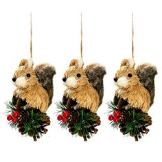 three christmas ornaments hanging from strings with pine cones and red berries