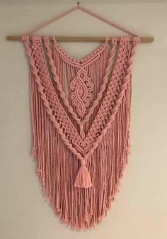 pink crocheted wall hanging with tassels