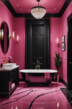 a bathroom with pink walls, black and gold accents and a claw foot bathtub