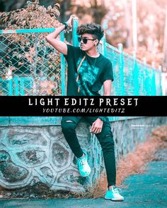 a young man sitting on top of a cement wall next to a fence with the words light editz preset