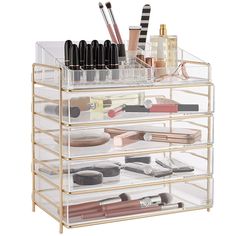 the makeup organizer is organized with clear drawers and lots of beauty products on it's sides