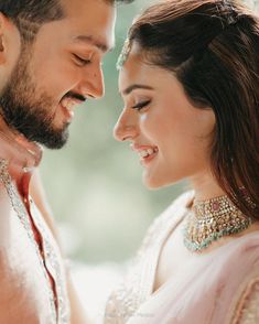 a man and woman smiling at each other