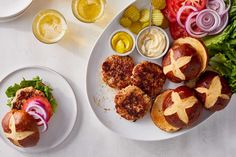 an assortment of food items displayed on white plates with sauces and condiments