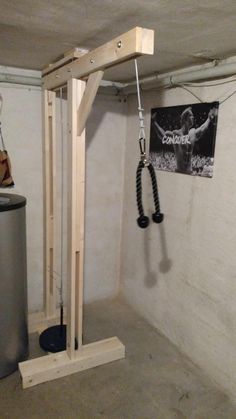 a gym room with an overhead pull up bar in the middle and a poster on the wall