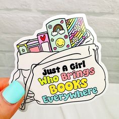 a person holding up a sticker that says, just a girl who brings books everywhere