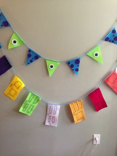 colorful paper pennants are hanging on the wall