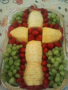 a platter filled with grapes, strawberries and bananas