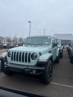 several jeeps are parked in a parking lot