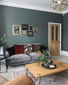 a living room filled with furniture and a wooden coffee table on top of a rug