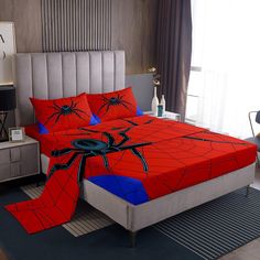 a spiderman bed with red and blue sheets on top of it in a bedroom