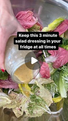 someone adding dressing to a salad in a bowl