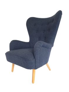 an upholstered blue chair with wooden legs and buttons on the armrests