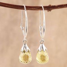 Like glittering dewdrops, two gemstones of faceted lemon quartz total ten carats. Indian artisan Tishita Jain creates these half-hoop-style dangle earrings, which are crafted with high-polish sterling silver. Faceted Briolette Teardrop Earrings, Faceted Citrine Drop Jewelry, Drop Citrine Gemstone Earrings, Yellow Gemstone Drop Earrings, Citrine Gemstone Drop Earrings, Teardrop Citrine Earrings For Anniversary, Yellow Faceted Teardrop Jewelry, Formal Faceted Teardrop Earrings, Yellow Faceted Dangle Earrings