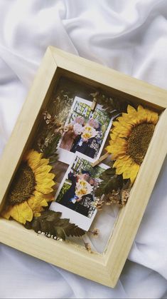 three photos in a wooden frame with sunflowers on the bed and white sheets